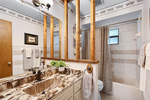 full bathroom with toilet, vanity, shower / bath combo with shower curtain, and tile patterned floors