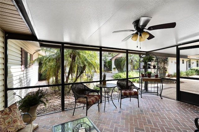 unfurnished sunroom with a ceiling fan