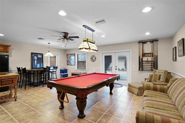 game room with a textured ceiling, french doors, visible vents, and recessed lighting