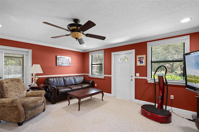 living room featuring carpet, a textured ceiling, plenty of natural light, and crown molding