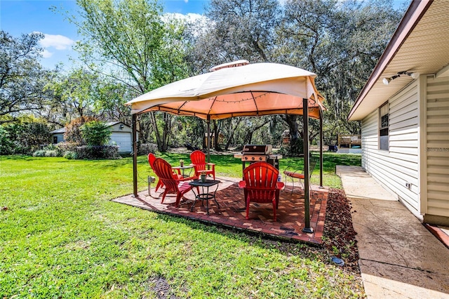 view of yard with a gazebo, a patio, and an outdoor structure