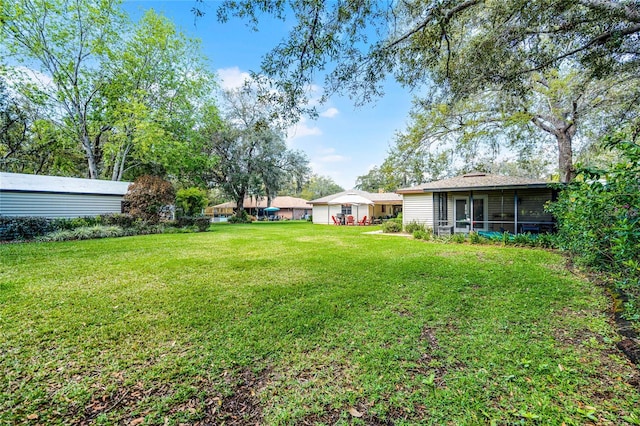 view of yard featuring a sunroom