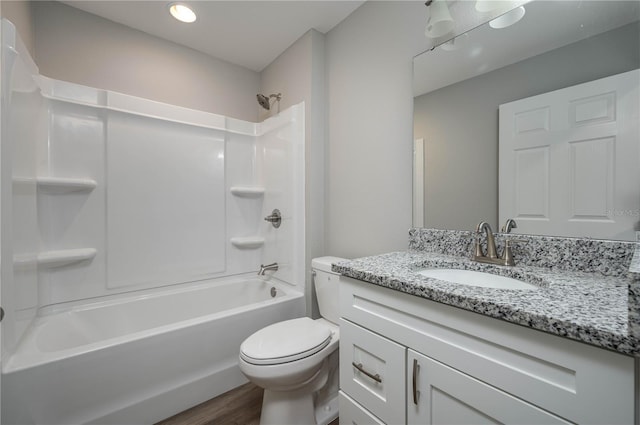 bathroom with wood finished floors, tub / shower combination, vanity, and toilet