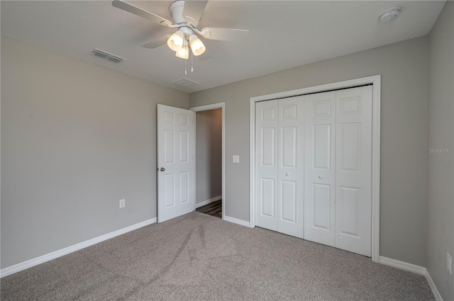 unfurnished bedroom featuring a closet, carpet, visible vents, and baseboards