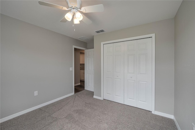 unfurnished bedroom featuring carpet floors, a closet, visible vents, a ceiling fan, and baseboards