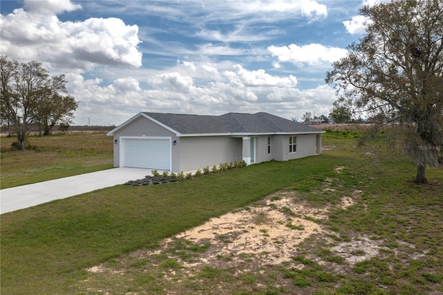 ranch-style house with concrete driveway, stucco siding, an attached garage, and a front yard