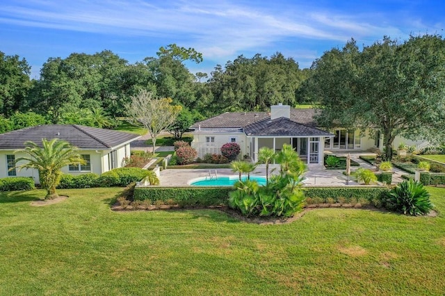 pool with a patio and a yard