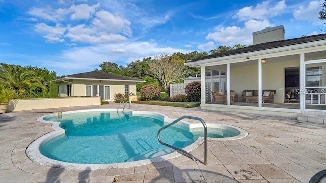 pool with a patio and an outdoor structure