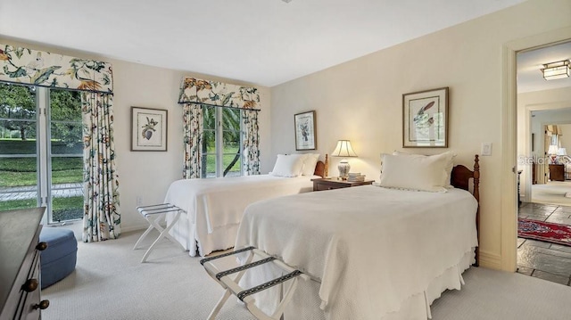 bedroom featuring carpet floors and multiple windows