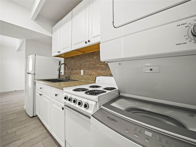 kitchen with decorative backsplash, white electric range, light wood-type flooring, white cabinetry, and a sink