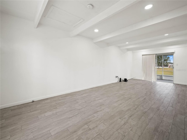 spare room featuring recessed lighting, beam ceiling, baseboards, and wood finished floors