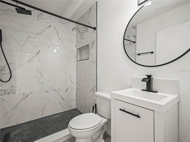 bathroom featuring a stall shower, vanity, and toilet