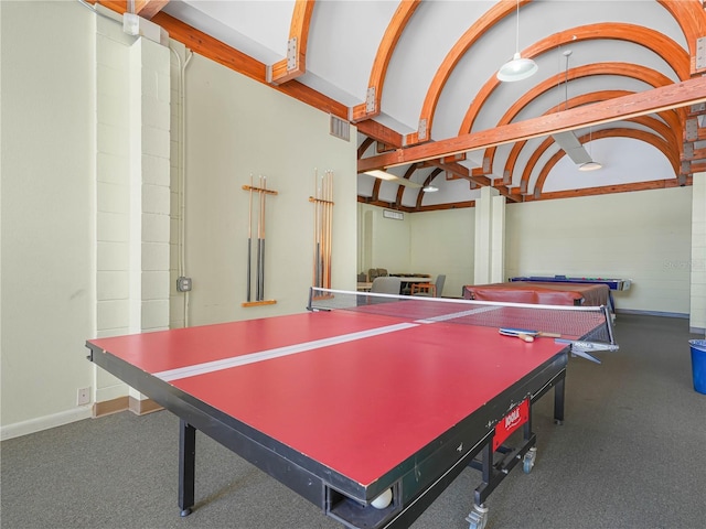 recreation room with baseboards, visible vents, and vaulted ceiling