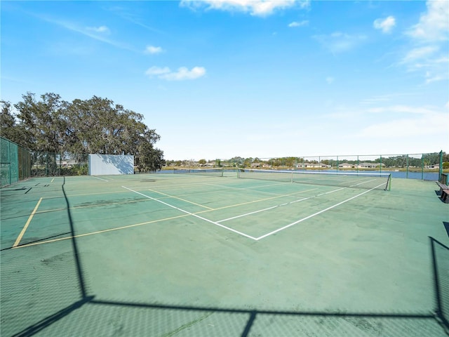 view of tennis court with fence