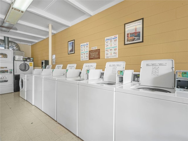 common laundry area with stacked washer and dryer and washing machine and clothes dryer