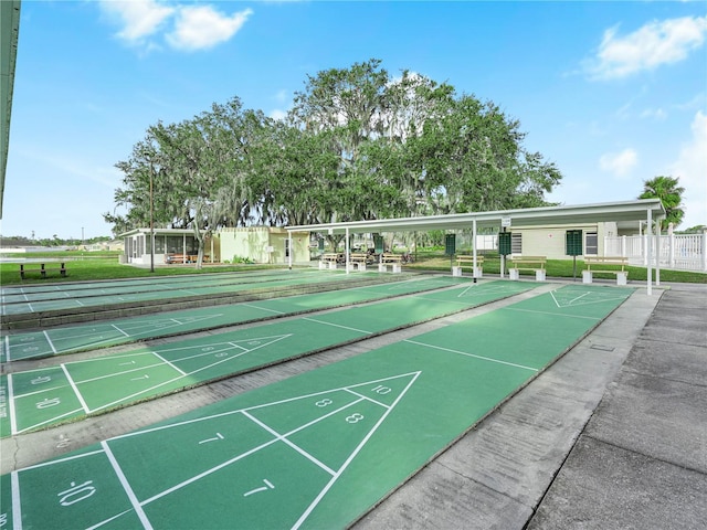 surrounding community with shuffleboard and fence