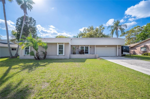 single story home with a garage, driveway, a front yard, and stucco siding