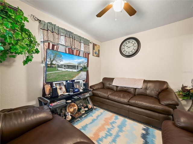 living area with a ceiling fan