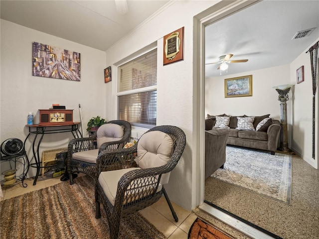 sitting room featuring a ceiling fan, tile patterned flooring, and visible vents