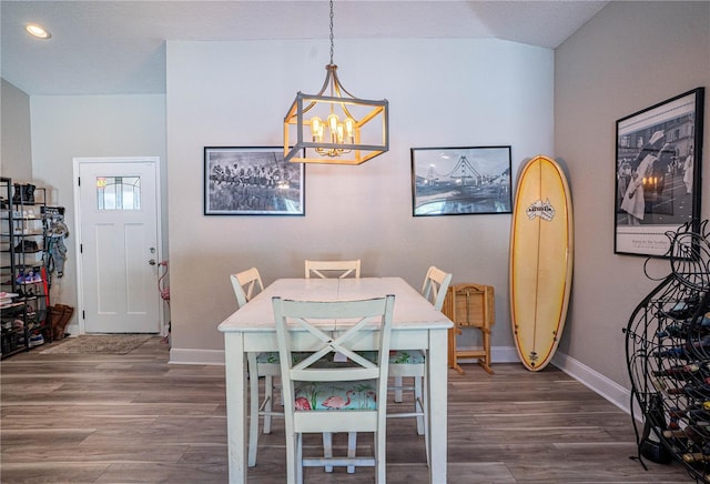 dining room featuring a chandelier, recessed lighting, dark wood finished floors, and baseboards