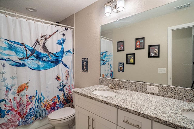 full bathroom featuring visible vents, a textured wall, vanity, and toilet