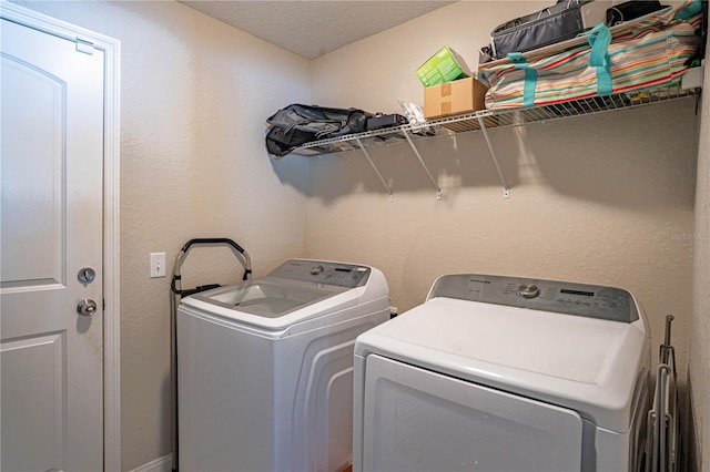 washroom featuring washing machine and dryer and laundry area