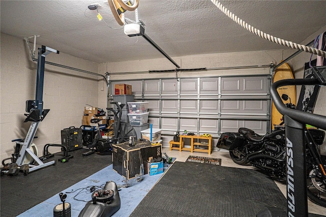 garage featuring concrete block wall and a garage door opener