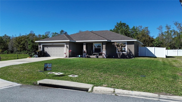 ranch-style home featuring driveway, an attached garage, fence, a front yard, and stucco siding