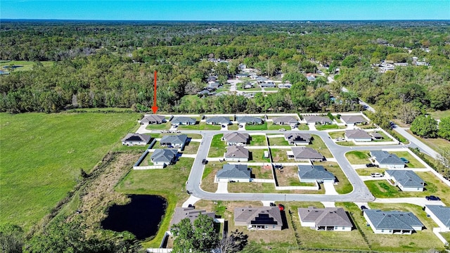 aerial view with a water view, a residential view, and a wooded view