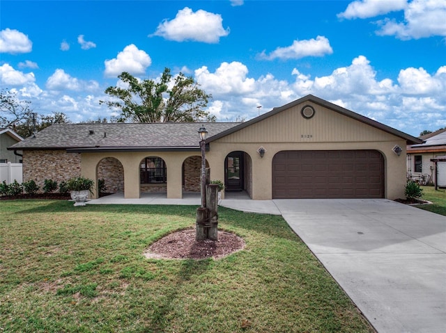 single story home featuring an attached garage, fence, concrete driveway, and a front yard