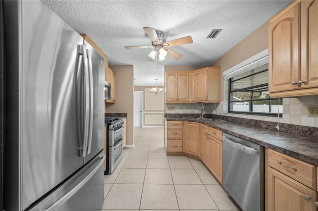 kitchen with light tile patterned floors, stainless steel appliances, dark countertops, tasteful backsplash, and light brown cabinetry