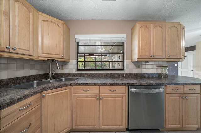 kitchen with light brown cabinets, a sink, dishwasher, tasteful backsplash, and dark countertops