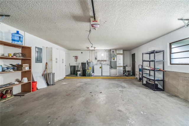 garage featuring water heater, a garage door opener, a sink, and washing machine and clothes dryer