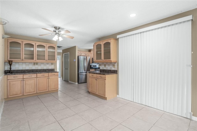 kitchen with light tile patterned floors, tasteful backsplash, glass insert cabinets, freestanding refrigerator, and a ceiling fan