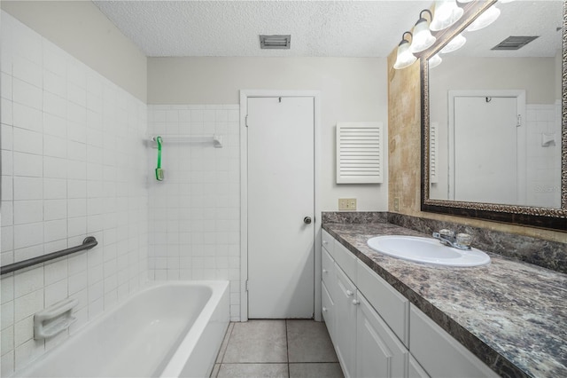 full bathroom with tile patterned flooring, visible vents, a textured ceiling, and vanity