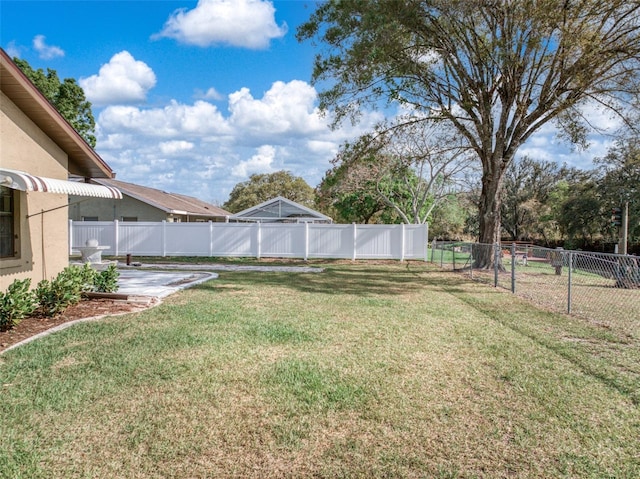 view of yard with a fenced backyard