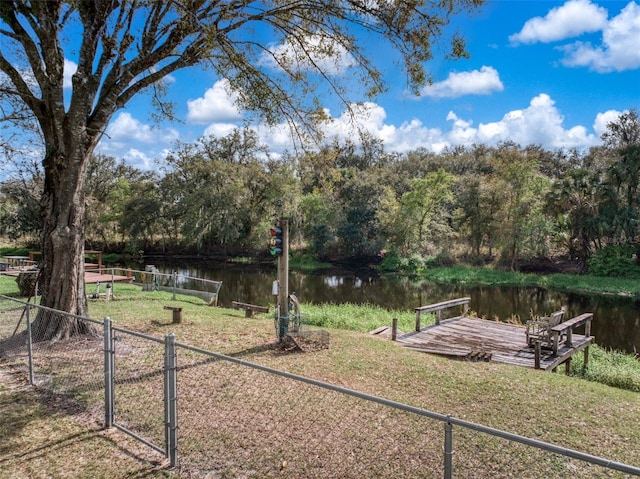 view of yard with a water view and fence