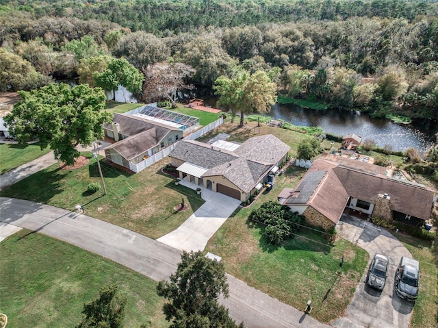 drone / aerial view featuring a water view and a view of trees