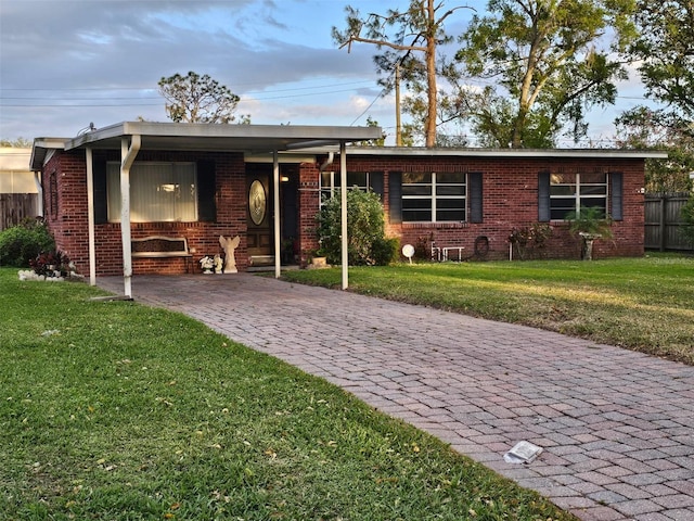 single story home with fence, a front lawn, decorative driveway, and brick siding