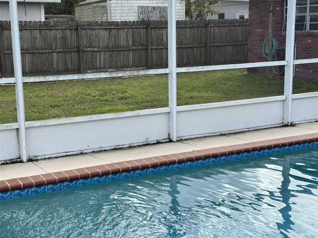 view of pool featuring fence, a fenced in pool, and a yard