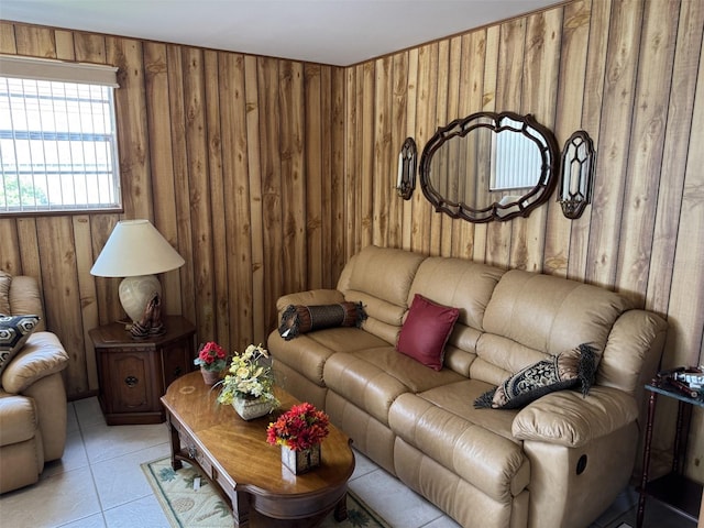 living room featuring wooden walls and light tile patterned flooring