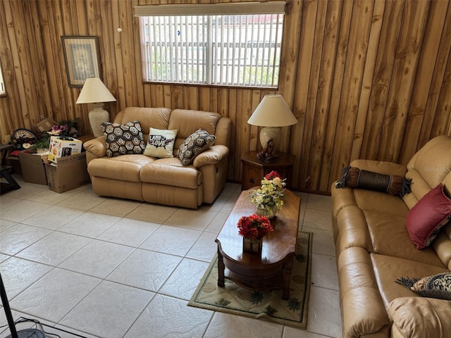 living room featuring light tile patterned floors and wood walls