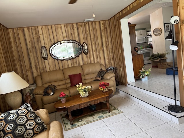 living room featuring visible vents, wooden walls, and light tile patterned floors