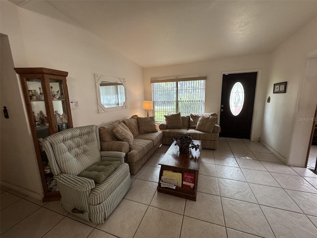 living room with lofted ceiling and light tile patterned floors