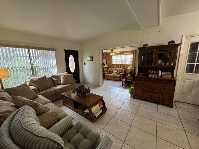 living area featuring light tile patterned floors and vaulted ceiling