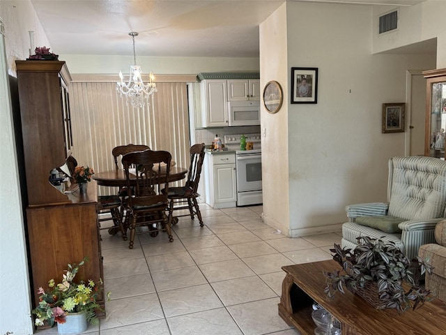 dining room with light tile patterned flooring, visible vents, baseboards, and an inviting chandelier