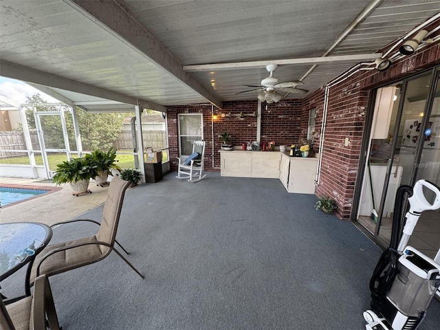 view of patio / terrace with an outdoor pool, glass enclosure, fence, and ceiling fan