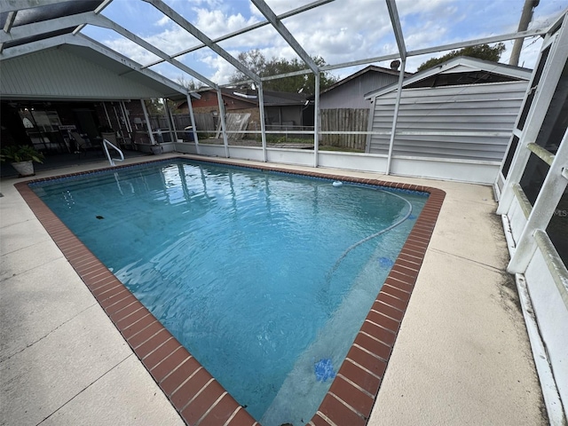 view of swimming pool featuring a fenced in pool, a lanai, a patio, and fence