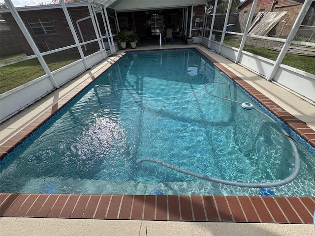 view of swimming pool featuring a lanai, a fenced in pool, and a patio