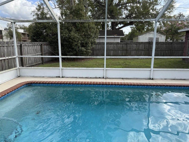 view of swimming pool featuring a fenced backyard, a fenced in pool, and a lanai